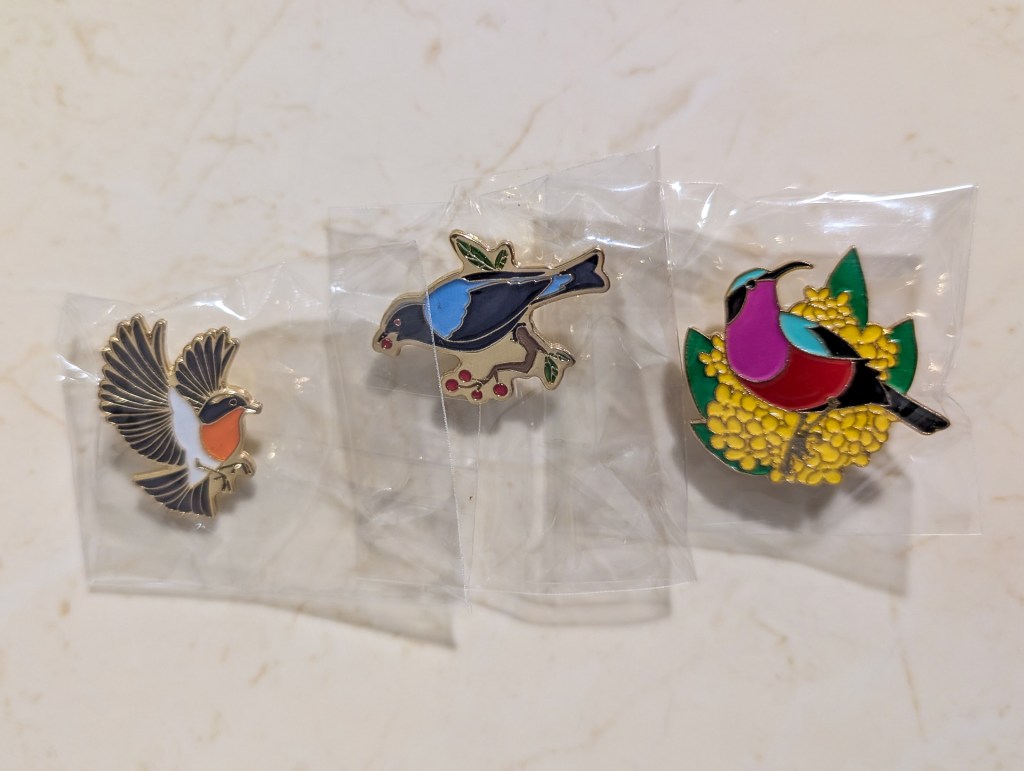 Metal pins merchandise from the Bird Society of Singapore